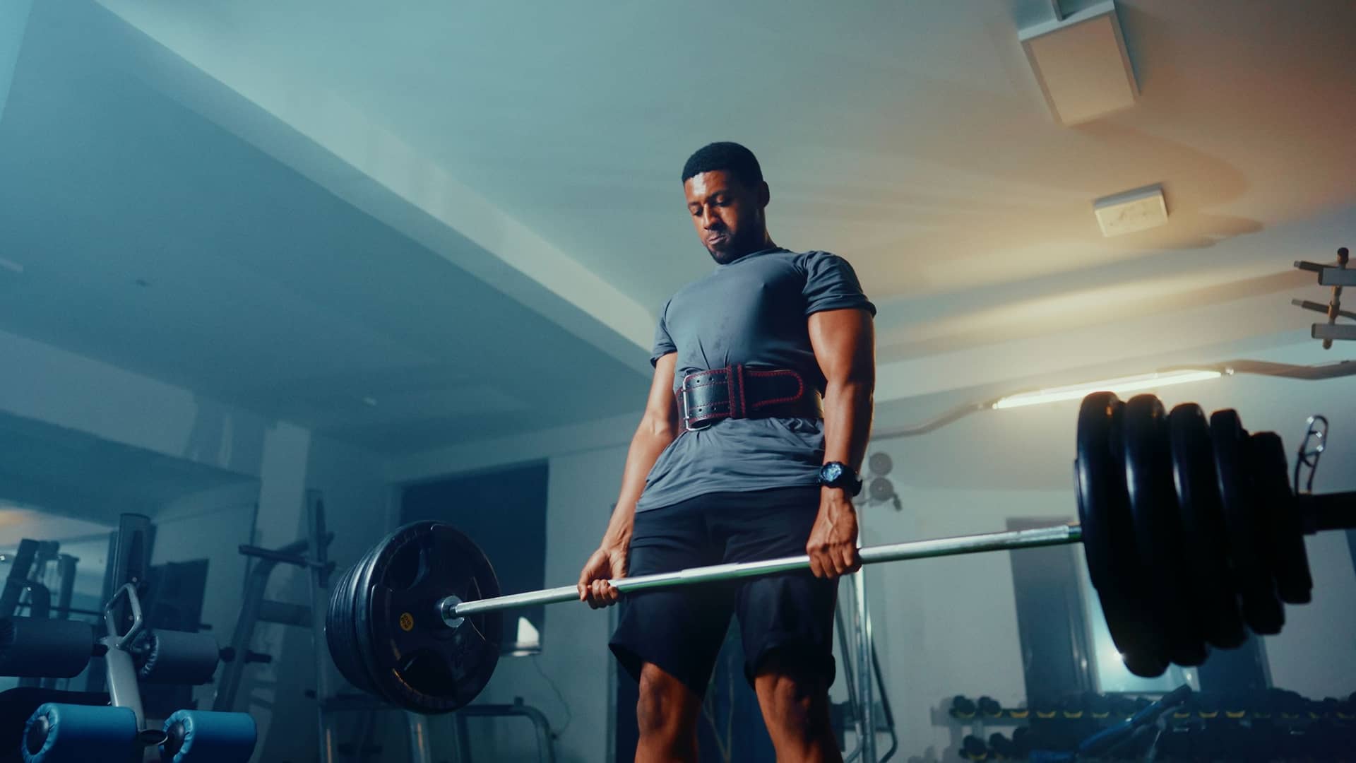 Man performing a deadlift in a gym